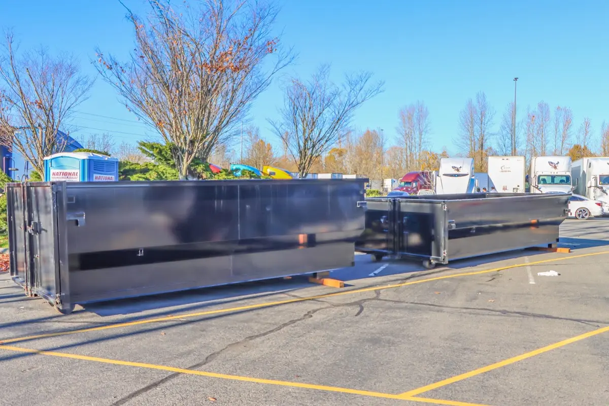 Professional dumpster rental service with roll-off container on residential driveway in Yulee